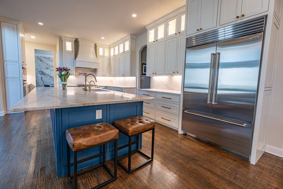 Spacious kitchen featuring marble countertops, a center island and stainless steel appliances